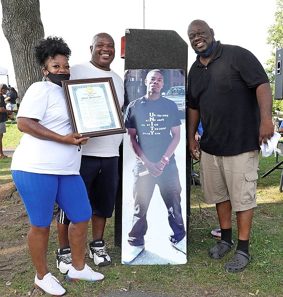 Rowland, N.C., resident Beverly Morgan, Irving Avenue resident Danny Davis and Derek Vincent, a Rye resident who helped organize Unity Day, pose with a photo of Morgan’s son Deshan O’Keith Bishop Davis, who died at 34 years old on June 24, 2020. Davis, known as “Chopz,” worked with kids at the Don Bosco Center, Carver Center and Beyond the Game Connection basketball program. Morgan received a proclamation signed by Mayor Luis Marino honoring her son.
