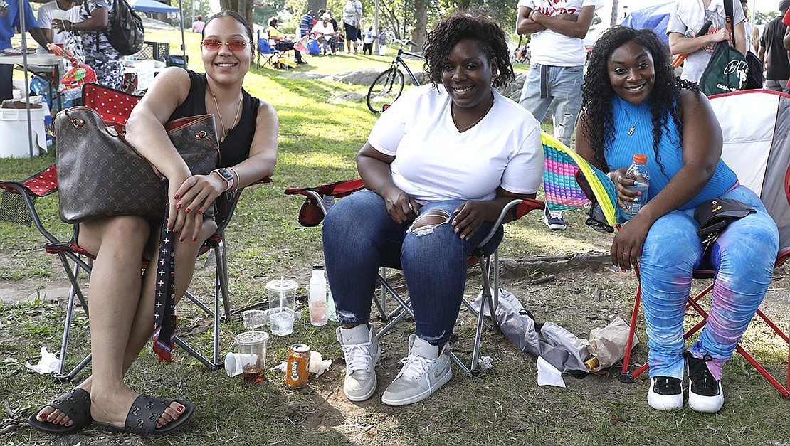 From left, Weber Drive resident Cortney Harris, Purdy Avenue resident Brittany Foust and Purdy Avenue resident Shakera Foust sit together in lawn chairs at Unity Day.