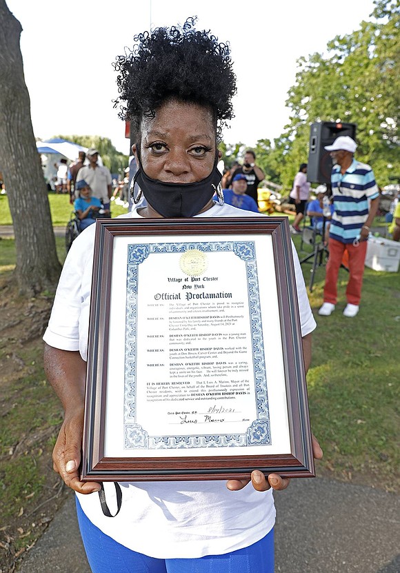 Beverly Morgan, who lives in Rowland, N.C., holds a proclamation honoring her son Deshan O’Keith Bishop Davis, signed by Mayor Luis Marino.
