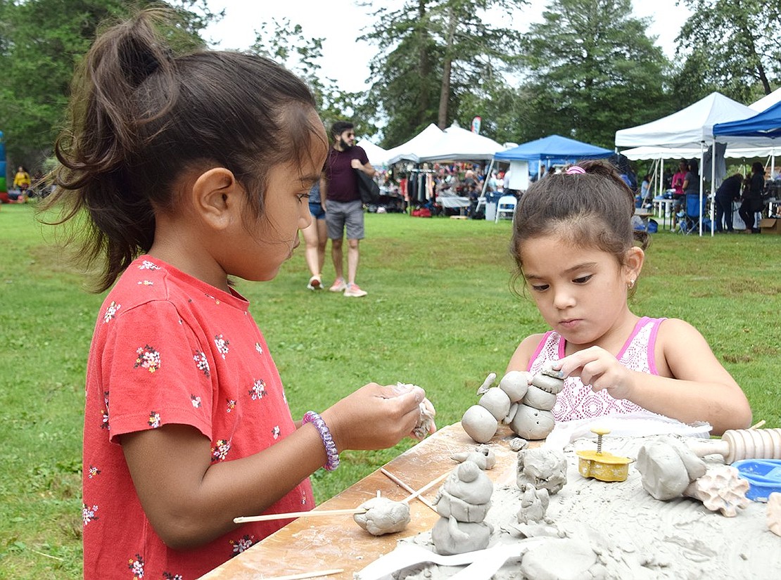 It may be August, but Alizah Jacob (left) and Madison Gomez find it’s the perfect season for snowman building at the Clay Art Center’s craft station. The King Street School rising kindergarteners said they would have spent all day at the table if they could.