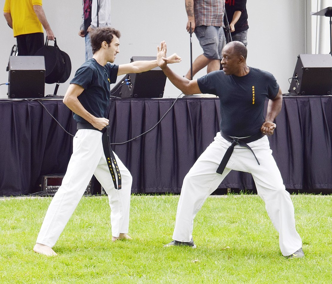 Black belts Jimmy Mitchell (left) and Russell Fulmore, of Port Chester and White Plains, respectively, reveal the secrets behind self-defense during the Rico Dos Anjos karate demonstration.