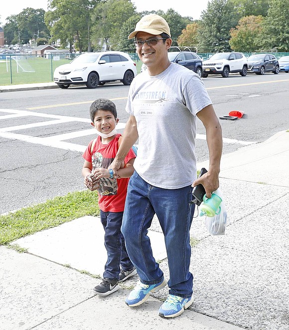 Park Avenue School first-grader Zahid Cabrera walks home with Ronald Cabrera after school on Tuesday, Sept. 14.