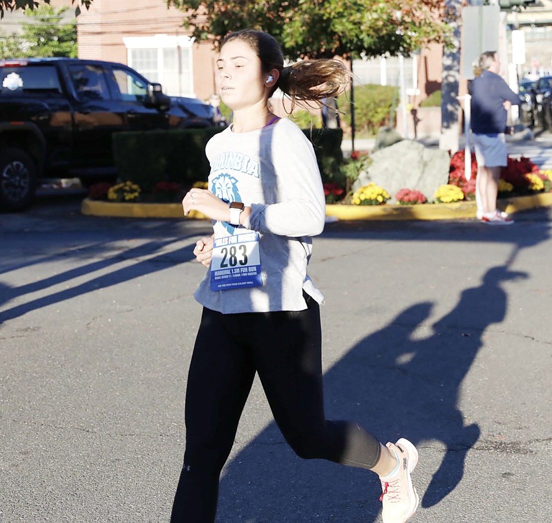 Port Chester resident Diana Mitova, who was the first woman to finish the race, is just inches from the finish line. She had a time of 9 minutes and 57.9 seconds.