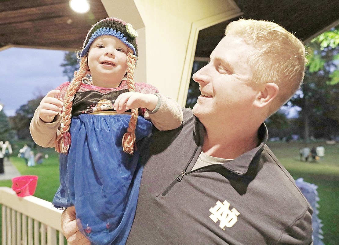 Reagan Moran, a 1-year-old Port Chester resident, dances in her father Rory Moran’s arms under the gazebo at Lyon Park during the Port Chester Recreation Department-sponsored Halloween in the Park on Wednesday, Oct. 27.