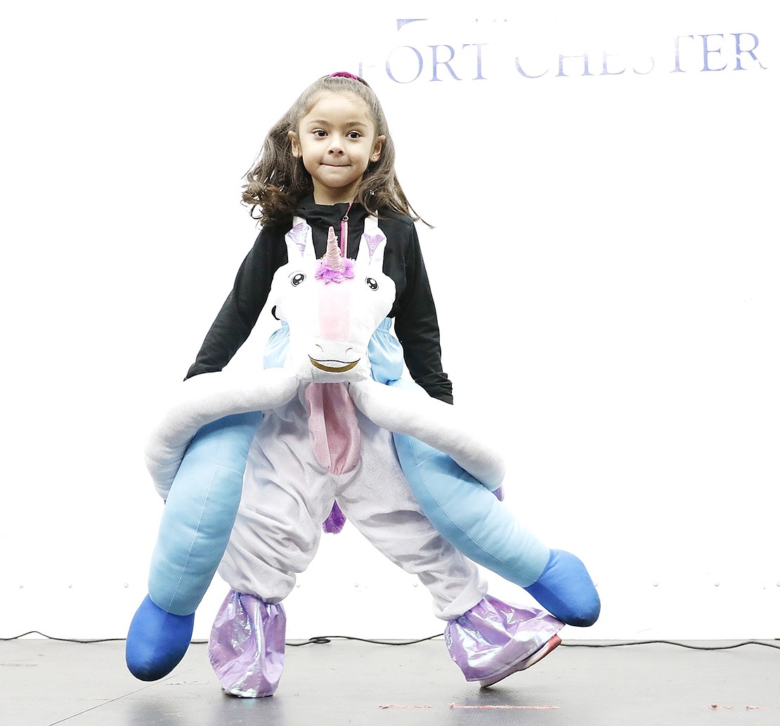 King Street Elementary School kindergartener Gabriella Dolores dances on the stage while wearing a costume depicting not just a unicorn, but a person riding one.