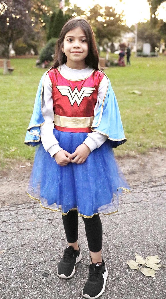 King Street Elementary School student Eva Lopez waits in line for candy in a Wonder Woman costume.