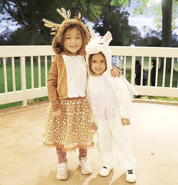 Leila Rossini, a 5-year-old dressed as a reindeer (left), takes a dancing break in the gazebo with 4-year-old Olivia Morales, dressed as a unicorn. Both attend pre-school in Port Chester.