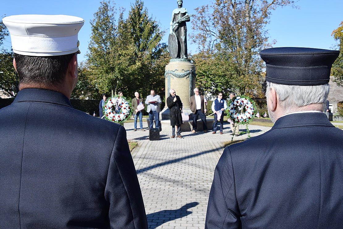 The Port Chester-Rye Town-Rye Brook Veterans Day ceremony honoring all veterans for their service proceeds as Port Chester firefighters in dress uniform watch from a distance at Veterans’ Memorial Park, corner of Westchester Avenue and North Regent Street, on Sunday morning, Nov. 7. 