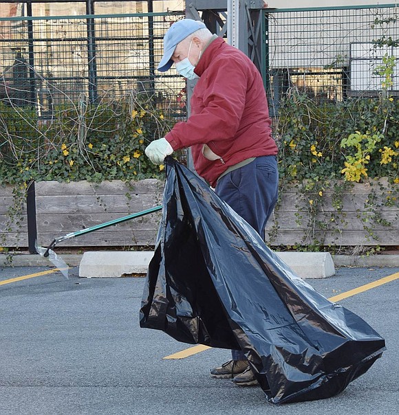 Community Cleanup Day—which encompassed Port Chester, Rye Brook and the City of Rye in a joint effort on Saturday, Nov. 6—attracted people of all ages. John Hofstetter of Milton Court picks up a piece of plastic from the Port Chester Metro-North commuter lot on Broad Street.