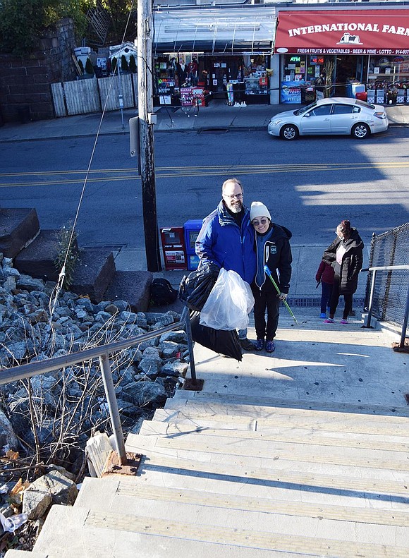 Salvatore and Nao Rotundo of Hobart Avenue head up the stairs from Westchester Avenue into the Port Chester Metro-North commuter lot on Broad Street after picking up trash at the Port Chester Marina.