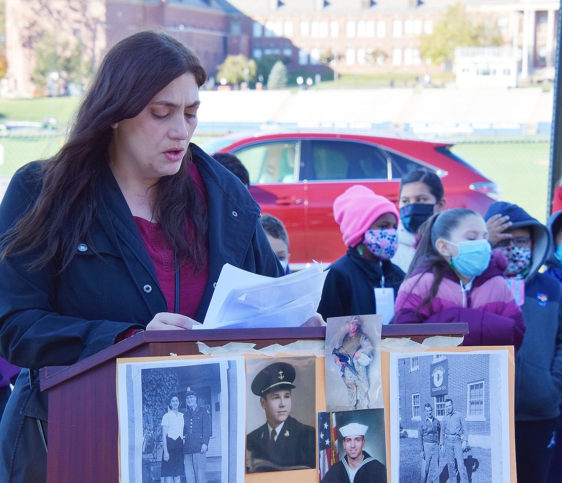 Park Avenue School teacher and event organizer Jennifer Carriero-Dominguez reads off the names of 52 local veterans who died during the past two years since a commemoration was not held last year due to COVID-19.