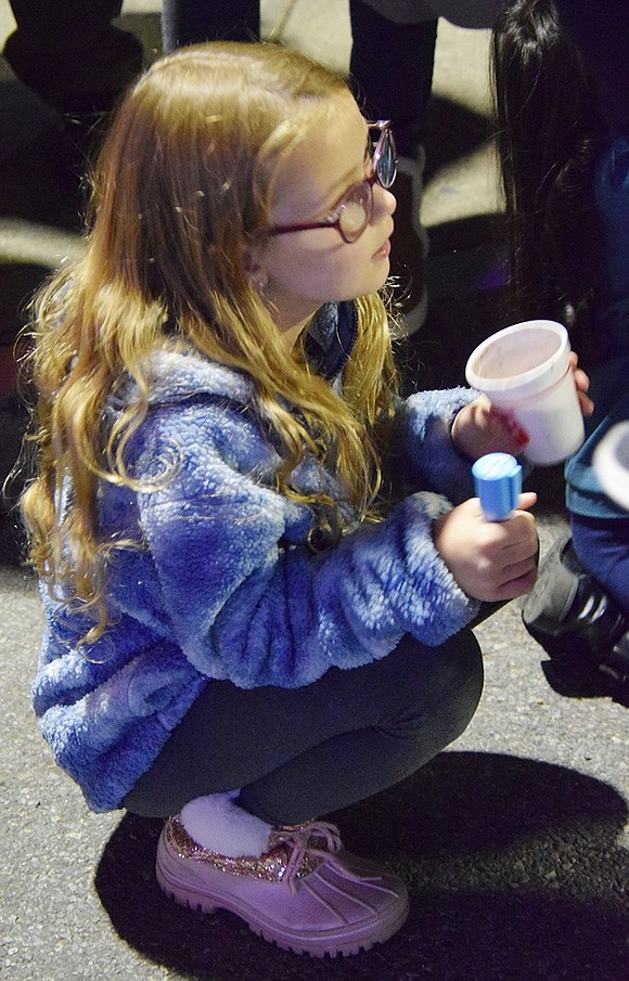 Eight-year-old Arianna Butkiewicz of Locust Avenue listens to the music and sips her hot chocolate.
