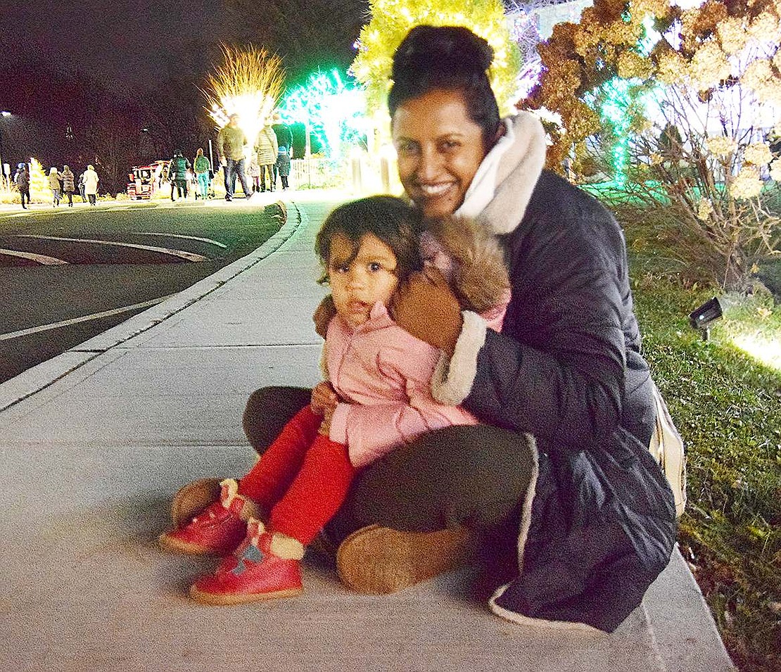 Waiting for the kiddie train to take them around Crawford Park, Rye resident Samita Schroeder and her 2-year-old daughter Sydney cozy up to enjoy the lights together.