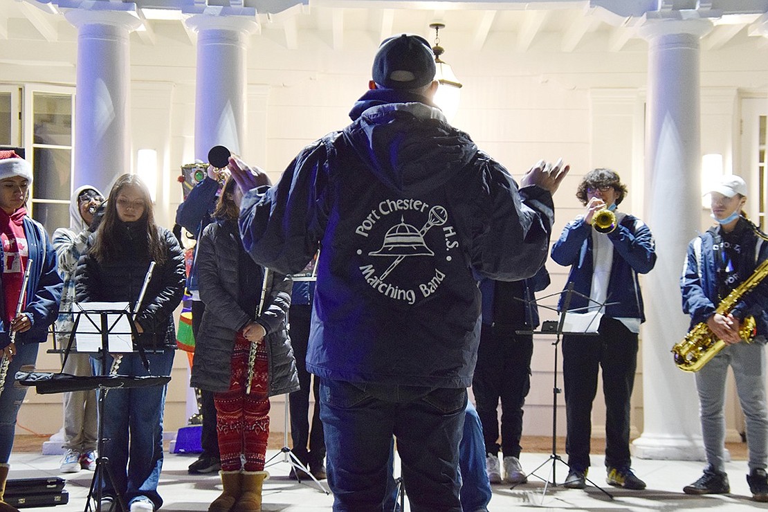 Eyes are on conductor Mike Miceli as the Port Chester High School band plays “Carol of the Bells” for Holiday Lights festival attendees relaxing by the food trucks.