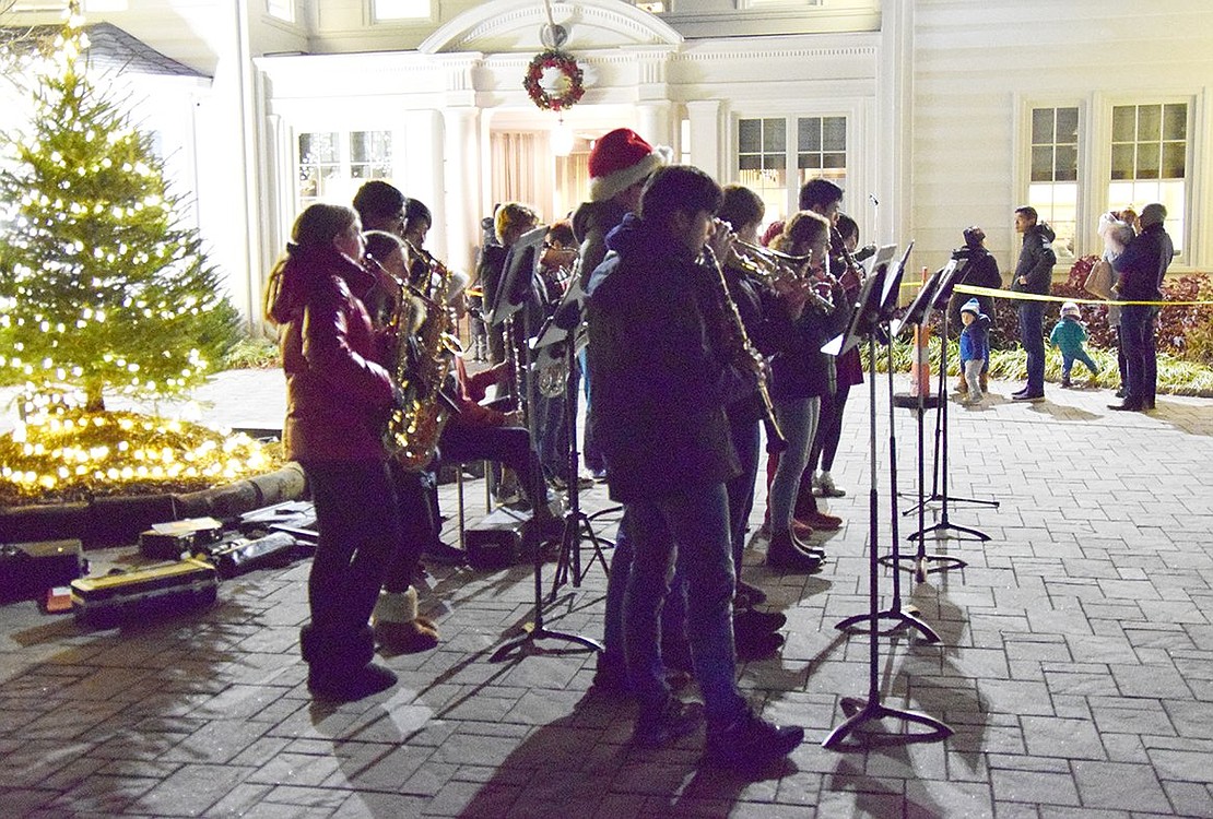 The Blind Brook High School band provides festive music for people to enjoy as they wait in line to meet Santa Claus inside the Crawford Mansion Community Center.