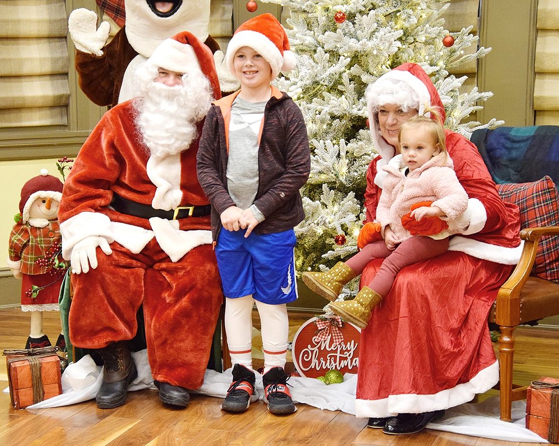 Greenwich, Conn. residents Hudson Nethercott, 7, and his 18-month-old sister Ryder are looking just as jolly as Santa and Mrs. Claus.