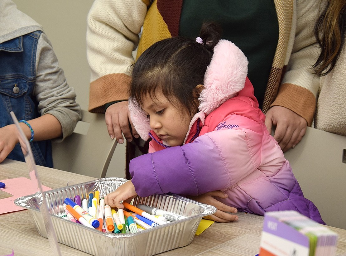 Pearl Street, Port Chester, 3-year-old Valentina Franco goes on a mission to find the best markers for her holiday greeting card in the arts and crafts room.