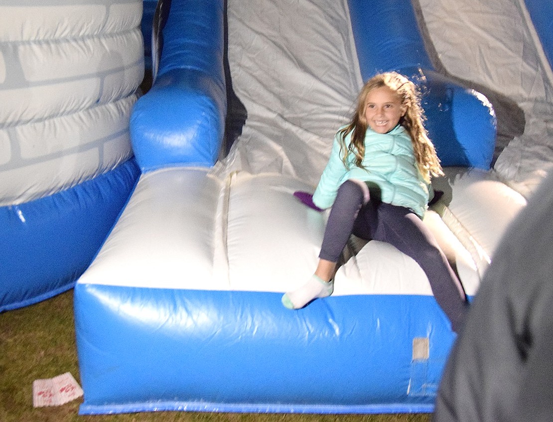 After zooming down the obstacle course slide, Victoria Allmashy, a King Street School first-grader who lives in Rye Brook, is all smiles and ready to go again.