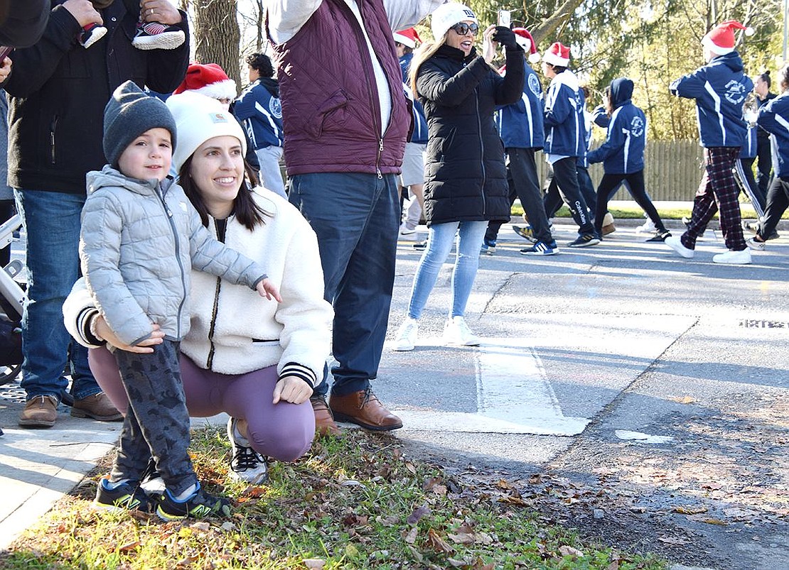 As the parade kicks off, turning the corner from Upland Street to King Street, Port Chester resident Jaclyn Godoy and her 3-year-old son Leo embrace the high energy and enjoy the holidays tunes.