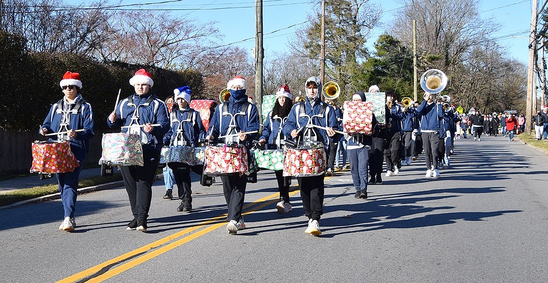 With appropriately wrapped instruments, the Pride of Port Chester drumline gives spectators the gift of beats as they lead the band down King Street. In front, from the left: junior Matthew Vintimilla, senior Mark Scocchera, senior Harrison Calloway and junior Tommy Borzoni.