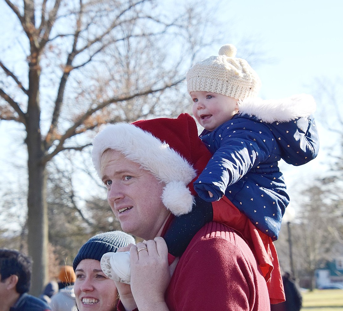 Taking advantage of having one of the best views in Lyon Park, 1-year-old Barrett Lane resident Maggie Hartnett’s eyes light up as she watches Santa take the stage from atop her father Tim’s shoulders.