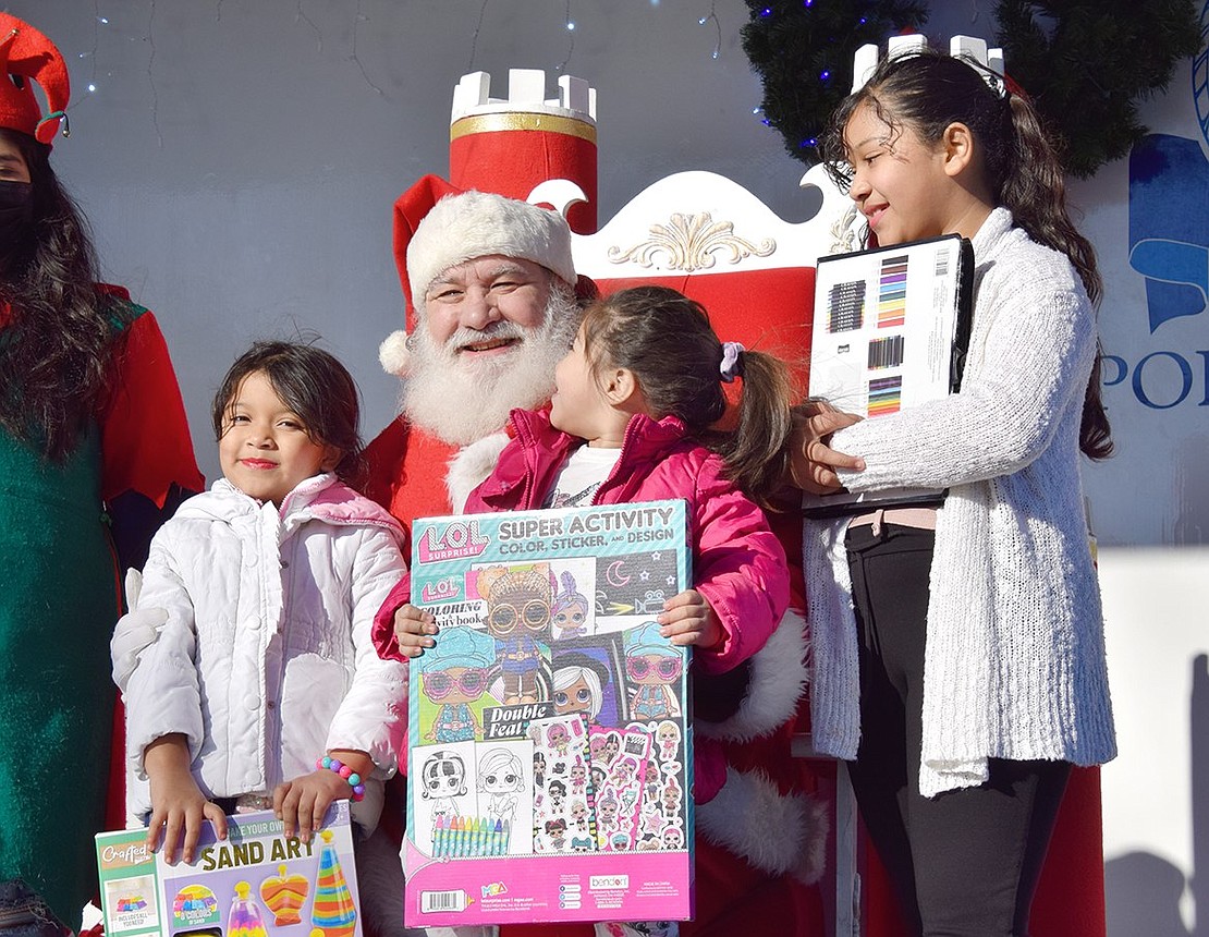 Port Chester’s Santos sisters are clearly enamored by Santa Claus (sometimes known as Charlie Sacco) when they get a moment to meet him in person. From the left: Alison, 7, Sofia, 3, and Keyri, 10.