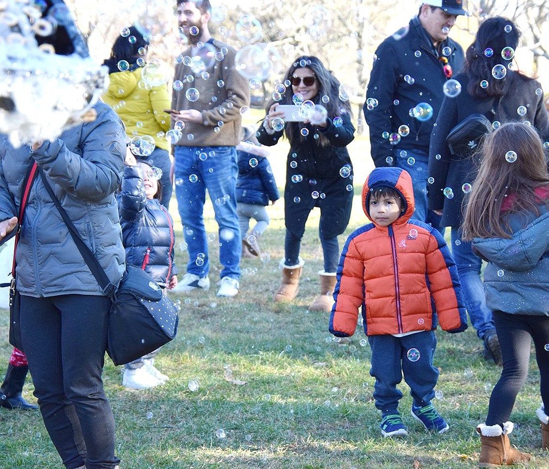 The lack of snow that weekend was made up for by the abundance of bubbles! Children dance around a bubble machine while parents mingle and snag a few photos.