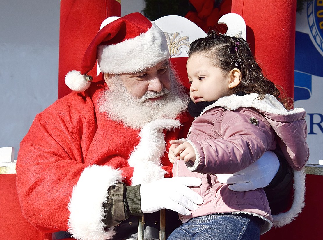 Santa Claus is taking his conversation with Port Chester resident Nefertari Rodriguez, 3, very seriously.