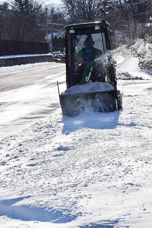 A Rye Brook Department of Public Works employee clears sidewalks on North Ridge Street in the vicinity of the bridge over the Hutchinson River Parkway.