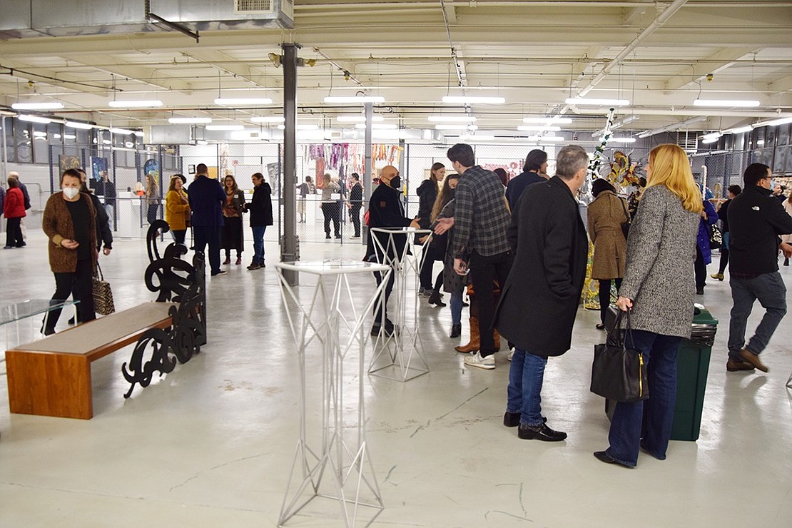 Sipping on wine and snacking on sweets while surrounding themselves with the immersive collection, a diverse group of artists and visitors mingle in the open-space gallery on the second floor of 40 Merritt St.