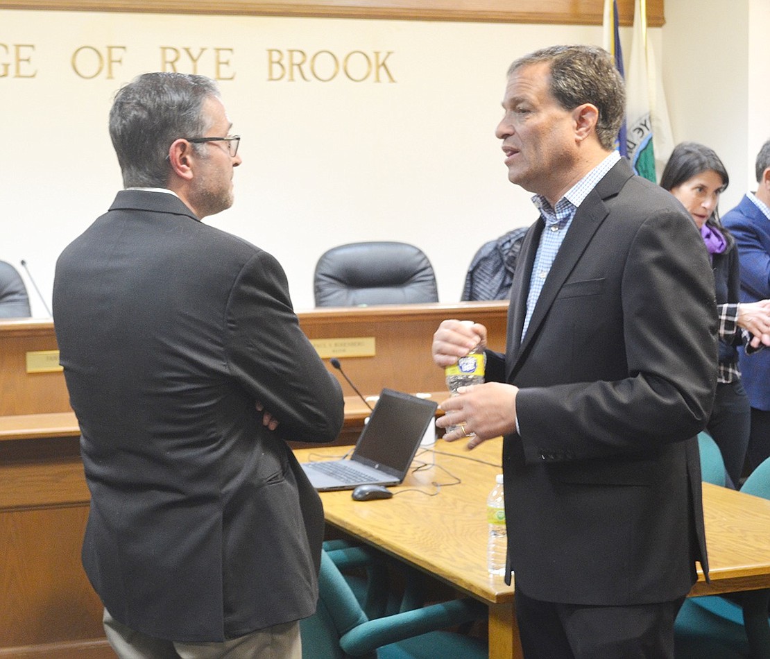 Over his nine years as mayor, Paul Rosenberg has taken new trustees under his wing to teach them the ropes. Here he talks to Trustee-elect Sal Morlino at Tuesday night’s reception.