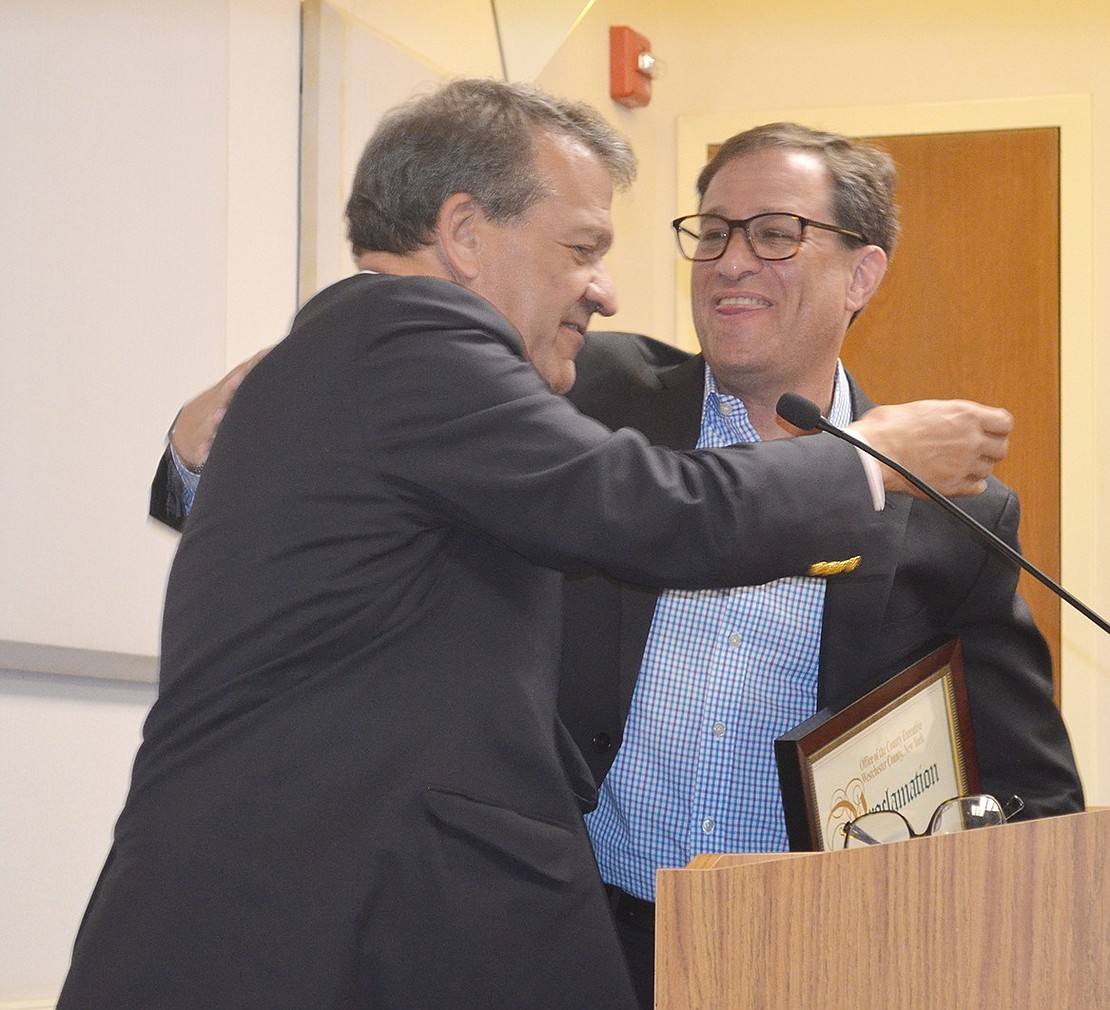 Outgoing Mayor Paul Rosenberg and County Executive George Latimer share a hug following Latimer’s always-eloquent remarks and presentation of a proclamation.