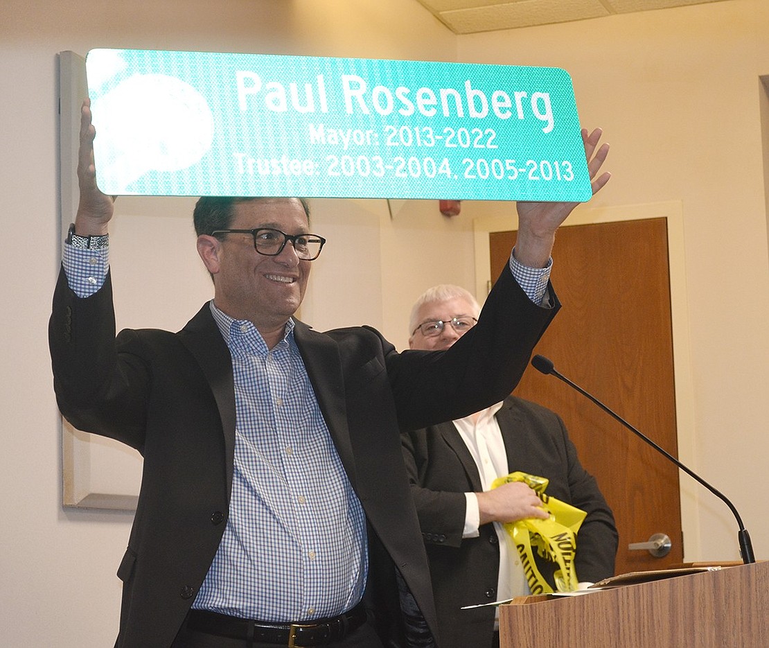 Paul Rosenberg holds up a sign with the Village of Rye Brook logo, his name and dates of service from the Department of Public Works. “I’m going on 17 years for a reason. You are one of them,” said Superintendent of Public Works Michal Nowak in presenting it.