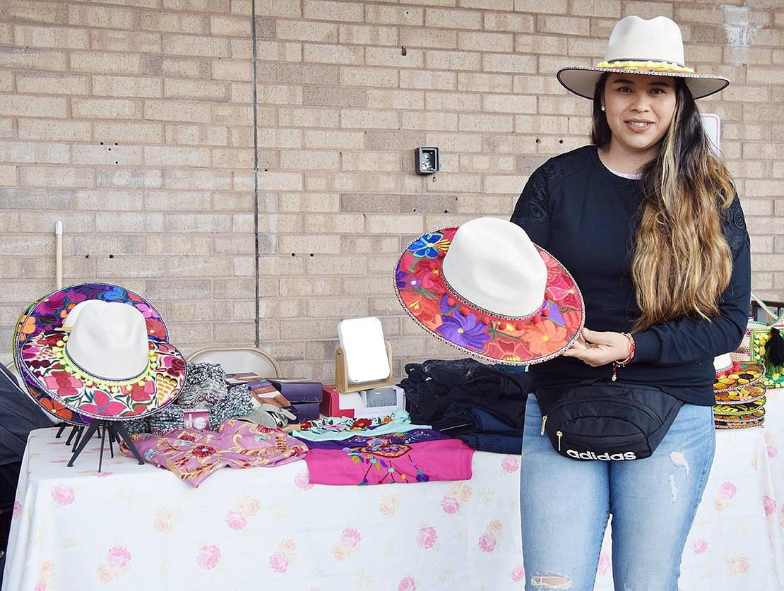 Elizabeth Valdovinos of Port Chester sports and displays Mexican hats she is selling.