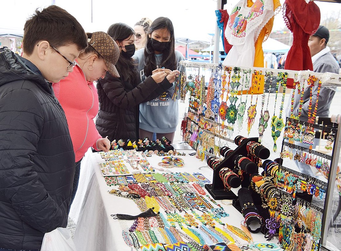Port Chester residents Gilda Marquez and her son Yerik Hernandez, 11, scan the multitude of jewelry on display at one of the many booths selling Mexican handicrafts.