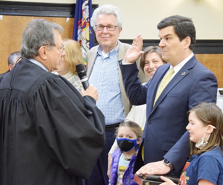 New Trustee John Allen takes the oath of office from Rye Town Judge José Castaneda. His 8-year-old daughter Samantha holds the Bible and his wife Jordan, 5-year-old daughter Ryan and parents John and Gloria Allen look on.