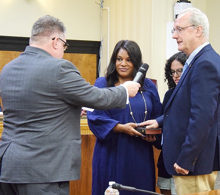 With his wife Roz holding the Bible and his 18-year-old daughter Keira by his side, Joe Carvin is sworn in as a new trustee by former Rye Town Councilman Bill Villanova.