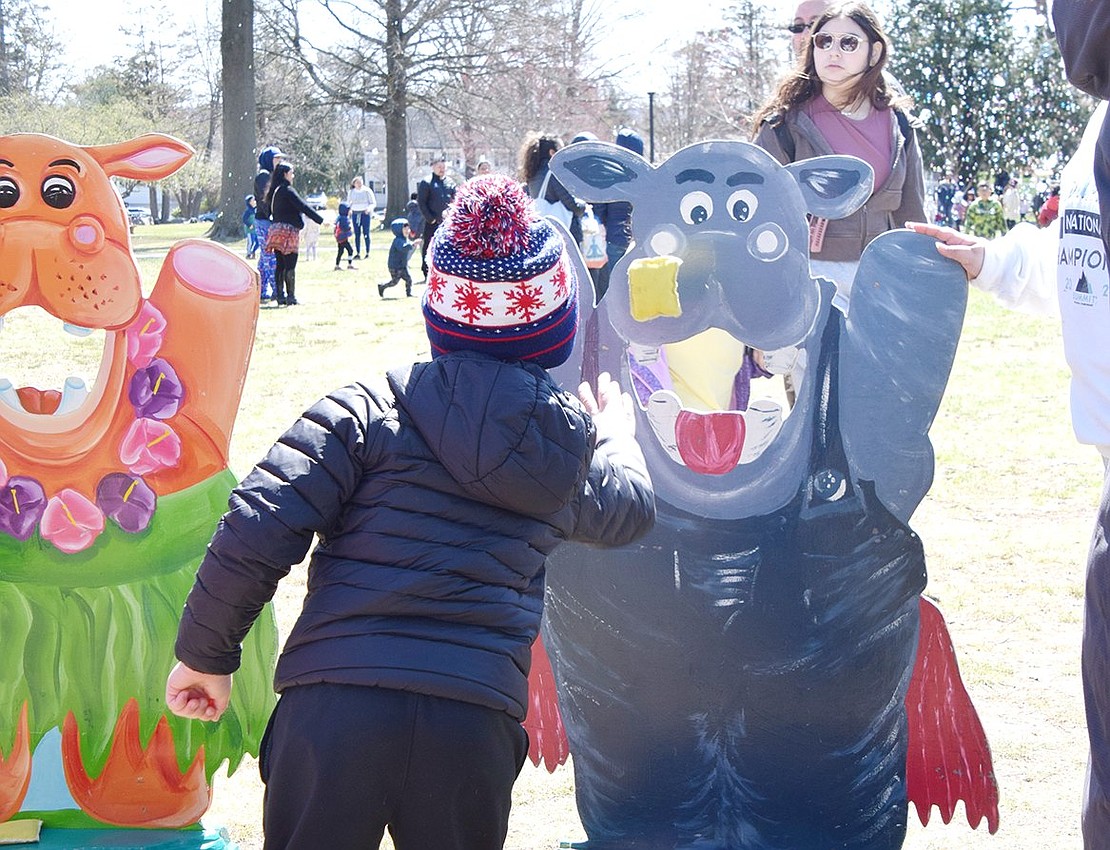 After taking his time to line up the shot, Browndale Place resident Mason Saffer, 5, tosses a yellow bean bag toward the mouth of a happy hippopotamus cutout.