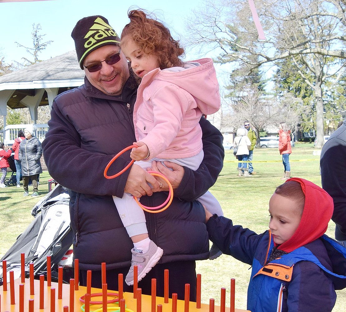 With a height advantage from her father Michael, Harrison resident Gianna Federici, 2, is able to conquer the ring toss carnival game with ease.