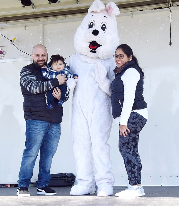 First time meeting the Easter Bunny: success. Port Chester residents Andrew and Judy Manousos pose for a family photo with their 8-month-old son, also Andrew, during Easter in the Park at Lyon Park on Saturday, Apr. 2.