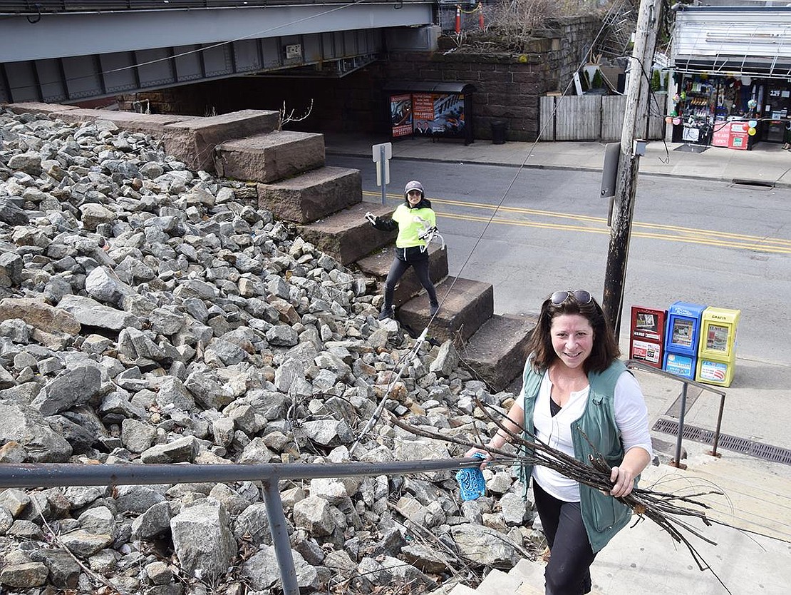 Concerned residents Chrissy Fay, who lives at The Mariner apartment building, and Nao Rotundo of Hobart Avenue spent Saturday morning picking up sticks and cleaning trash from the Metro-North property at the corner of Westchester Avenue and Broad Street.