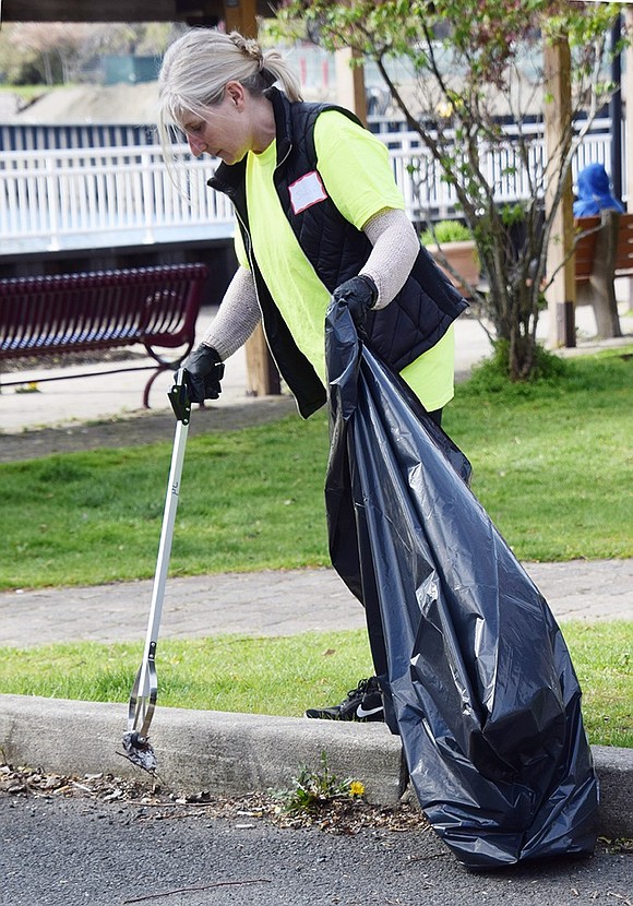 Julie Goodchild of Yorktown, who lived in Port Chester for eight years, picks up trash in the Port Chester Marina parking lot. She is a member of The Cap Cares Volunteer Rewards Program which runs monthly programs. Besides community service, the carrot is free tickets to concerts at The Capitol Theatre.