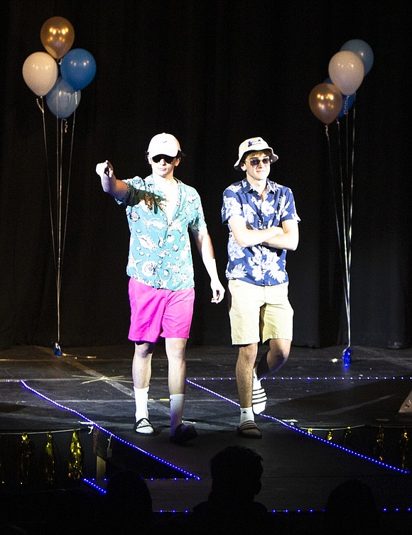 Seniors Euan Scott and Damian Otero model summer clothing from their own closets in the fashion show.