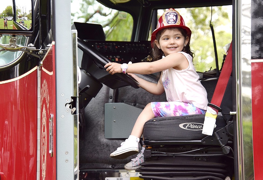 Grant Street resident Elena Malave is just a few years and a driver’s license away from becoming the newest Port Chester Fire Department hero. While showing off her new skills and swag earned during Port Chester’s 154th birthday party on Saturday, May 14, the 3-year-old takes a moment to look back at her mother for approval.