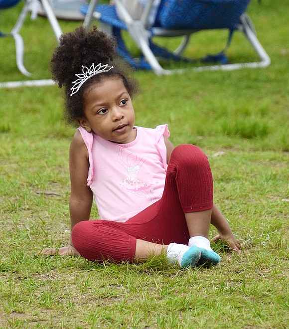 There’s a long line to the bouncy house, so 4-year-old Port Chester resident Keily Maccow wisely conserves her energy by sitting down for a rest during the wait.