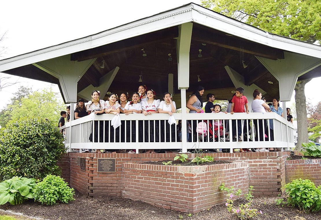 When a rainstorm sweeps through towards the end of the day, performers and guests take cover under the Lyon Park gazebo.