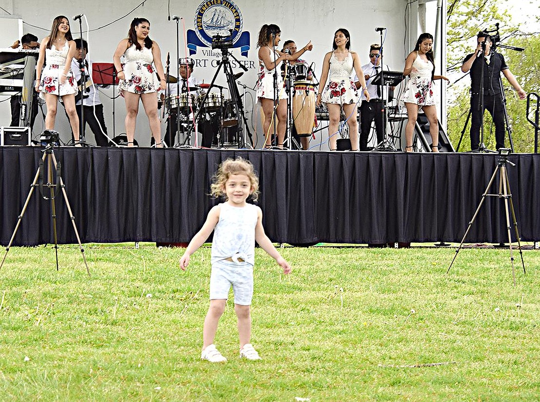 Imitation is flattery, as they say. West Glen Avenue resident Giada Lio, 4, gets inspired by the music and tries to move like the dancers behind her.