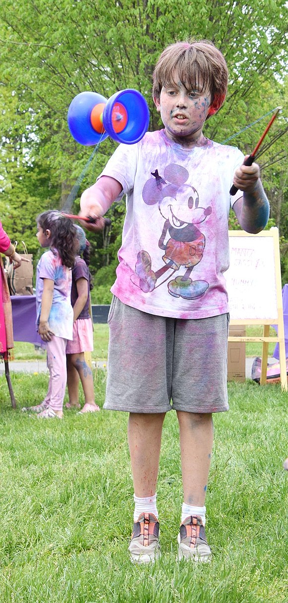 After getting appropriately coated in powder, Ridge Street Elementary School fourth-grader Oren Fery takes a break from the colorblasting to show off his skills on the diabolo.
