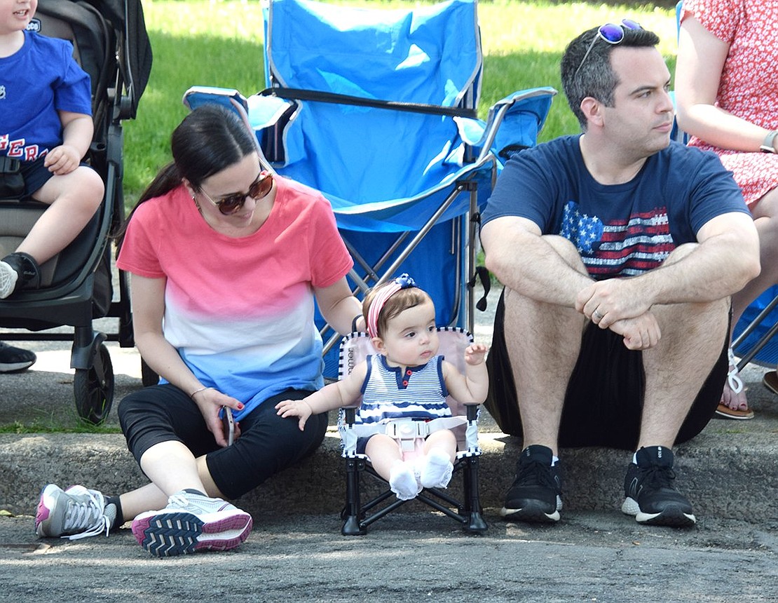 Madelyn Nangle, 11 months old, is intrigued by all the ruckus as she watches the parade pass by with her parents Mike and Teresa, a Port Chester native of the Florindi family who now teaches social studies at the middle school.