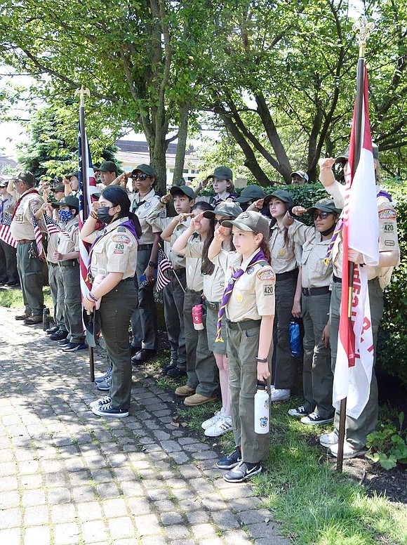 While “Taps” is played, Scouts in Port Chester BSA Girl Troop 420 salute in honor of all heroes who gave their lives to serve the country.